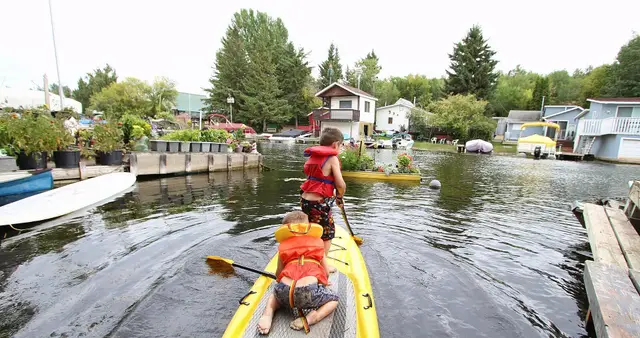 Kids on a paddle board in the lagoon