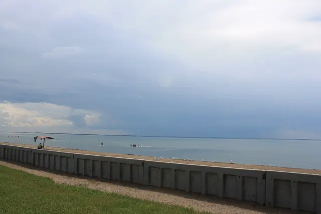 Beach and concrete seawall on the lake